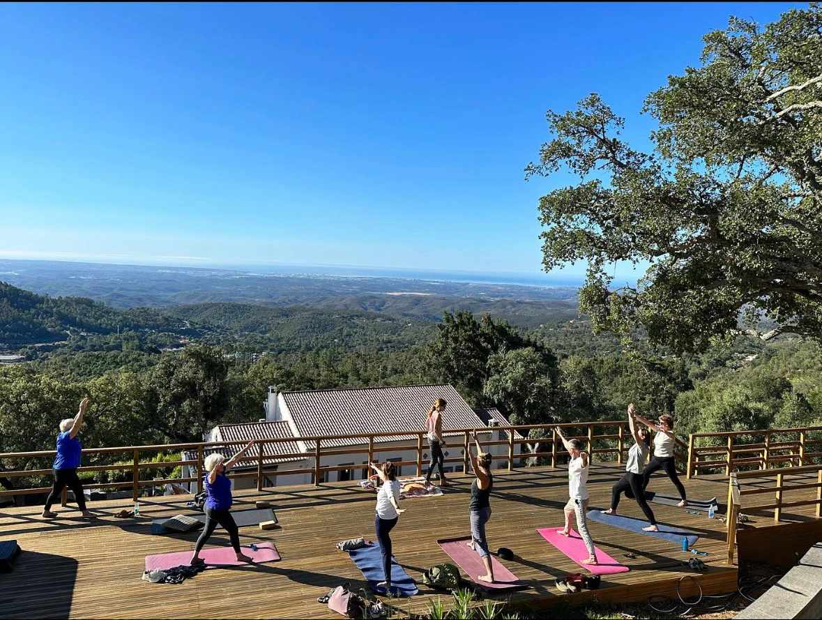 Outdoor yoga session on the VilaFoia mountain deck